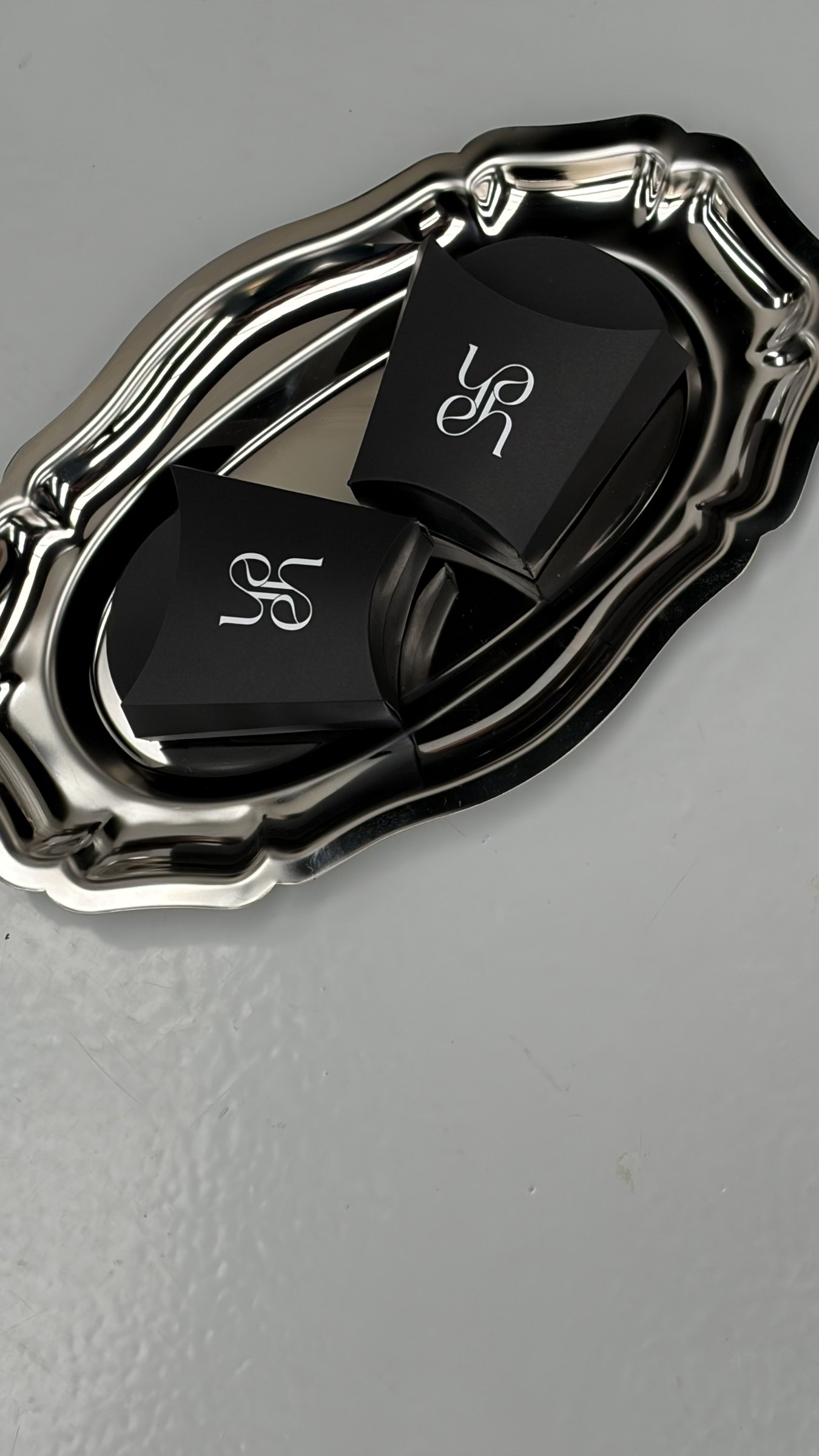 Branded product styling on a silver tray